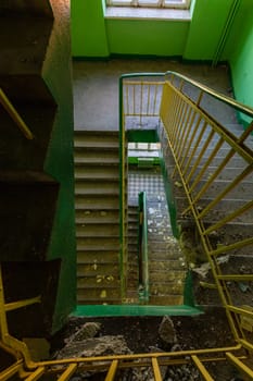 Top view of an old rectangular spiral staircase in an old abandoned building