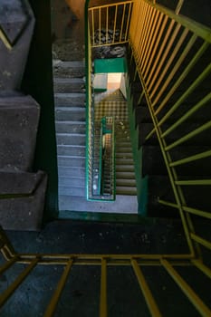 Top view of an old rectangular spiral staircase in an old abandoned building