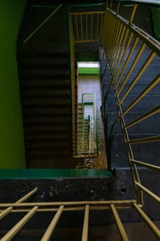 Top view of an old rectangular spiral staircase in an old abandoned building