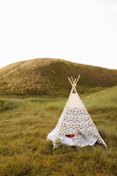 Children's sets for playing in the park. Wigwam with pillows in nature.
