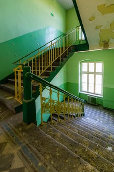 View of an old rectangular spiral staircase in an old abandoned building