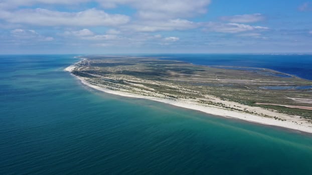 Aerial drone top down photo of seascape of island with sandy beach, turquoise clear waters of black sea in Ukraine and trees on island Dzharilgach