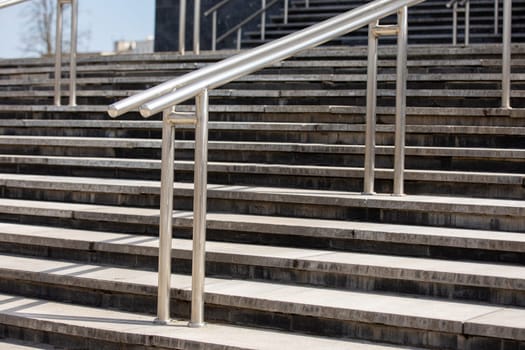 Outdoor Concrete Staircase With Stainless Steel Handrail, Front View, Close Up.