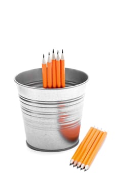 Isolated orange pencils on a clean white background in a metal bucket