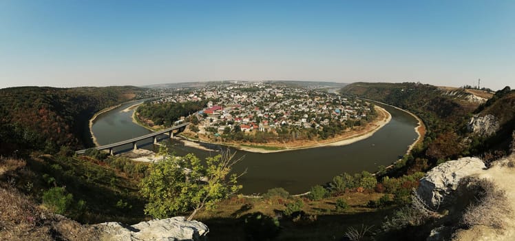 Top picturesque view of the summer Dnister river bend canyon and famous Ukrainian Zalischyky town. Ternopil region, Ukraine, Europe. miracles of nature. panorama.