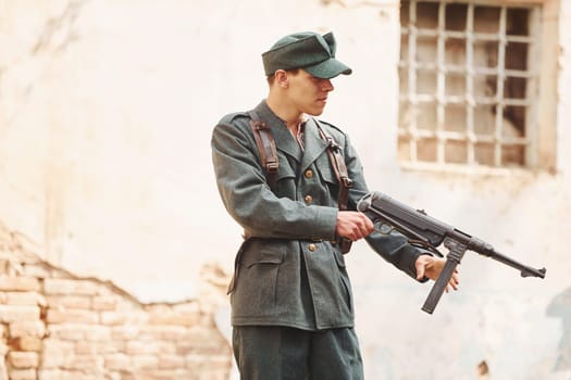 TERNOPIL, UKRAINE - June 2020 UPA Ukrainian Insurgent Army movie filming. Pictures of backstage. Young soldier with weapon near old building.