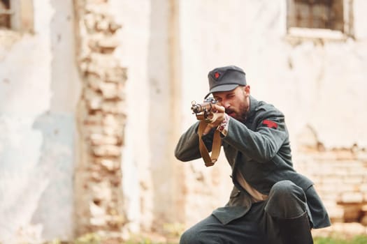 TERNOPIL, UKRAINE - June 2020 UPA Ukrainian Insurgent Army movie filming. Pictures of backstage. Young soldier with weapon near old building.