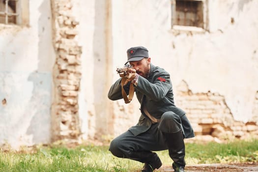 TERNOPIL, UKRAINE - June 2020 UPA Ukrainian Insurgent Army movie filming. Pictures of backstage. Young soldier with weapon near old building.