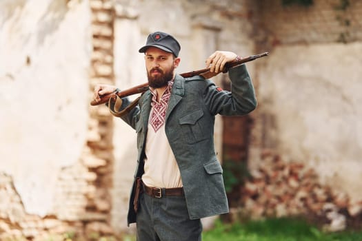 TERNOPIL, UKRAINE - June 2020 UPA Ukrainian Insurgent Army movie filming. Pictures of backstage. Young soldier with weapon near old building.