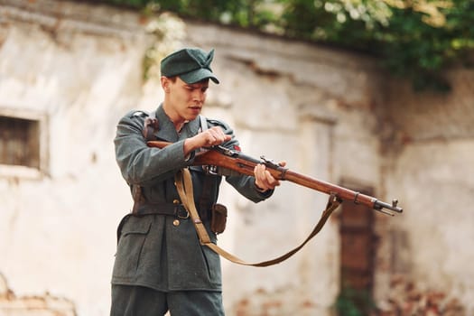 TERNOPIL, UKRAINE - June 2020 UPA Ukrainian Insurgent Army movie filming. Pictures of backstage. Young soldier with weapon near old building.