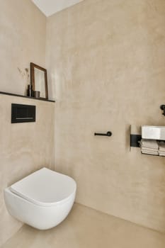 a toilet in the corner of a bathroom with shelves on the wall and an open door to the other room