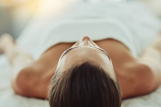 Realign and relax at a beauty spa. an attractive young woman getting pampered at a beauty spa