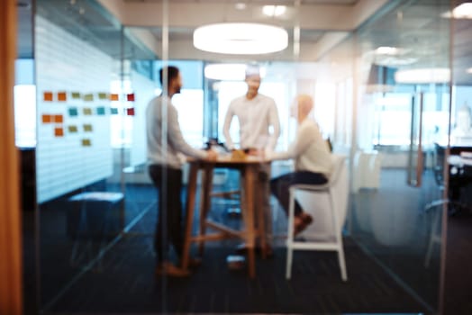 Strategy in action. Full length shot of three young businesspeople having a meeting in their office