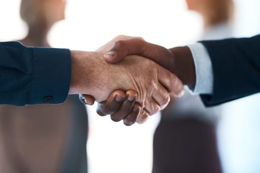 Well be great together. two unrecognizable businesspeople shaking hands in an office