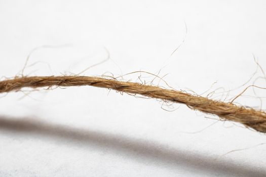 Skein of twisted yellow rope close up, isolated on white background