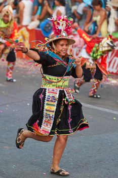 Arica, Chile - January 23, 2016: Tinkus dancing group in colourful costumes performing a traditional ritual dance as part of the Carnaval Andino con la Fuerza del Sol in Arica, Chile.