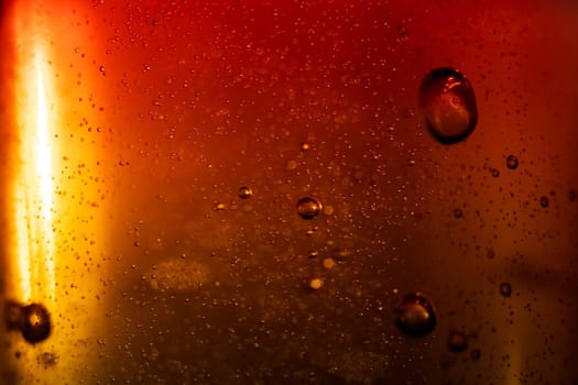 Bubbles in red water on a gray background close up