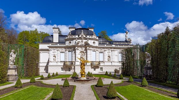 Part of the park with a fountain and sculptures of the Linderhof Palace in Bavaria, Germany, one of the castles of the former King Ludwig II. 