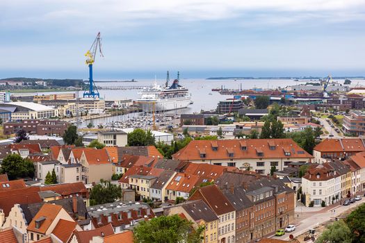 Wismar, Germany. Aerial view of the city and harbor with moored ship, harbor crane in the background 