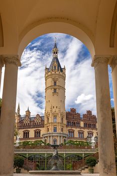 Schwerin Palace, view through the arch of the greenhouse with the tower of the Schwerin Palace, in the city of Schwerin, the capital of Mecklenburg-Vorpommern, Germany.