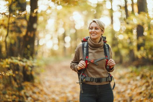 Shot of a mature woman walking through the forest in autumn.