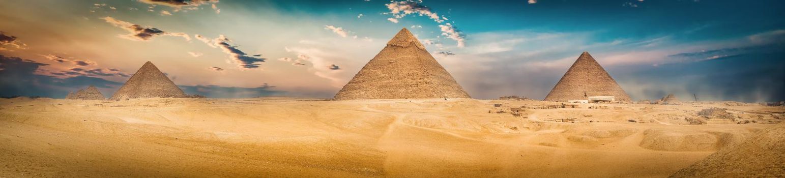 Egyptian pyramids in sand desert and clear sky