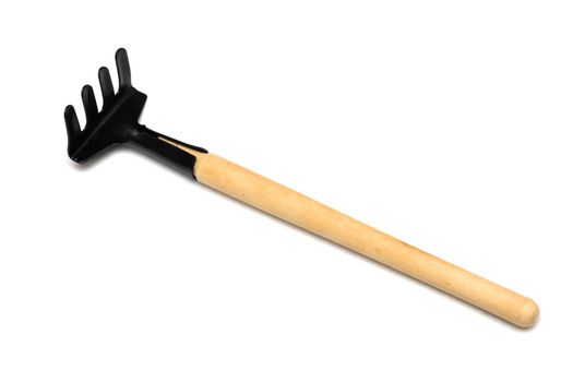 Small garden rake close up, isolate on a white background