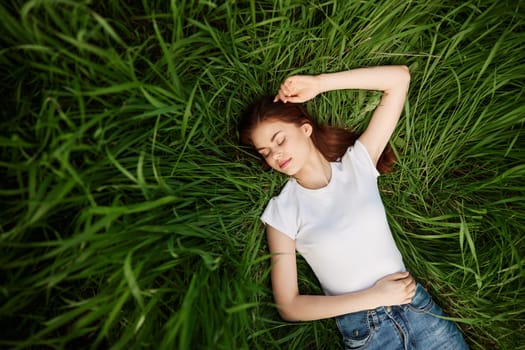 Young woman laying on meadow. High quality photo