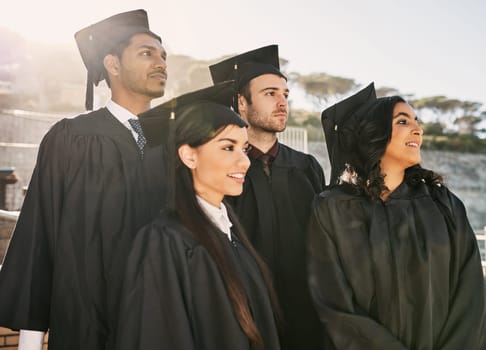 Keeping a positive outlook on their future. a group of students standing together on graduation day