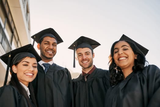 Education is a gateway into a world of opportunity. Portrait of a group of students standing together on graduation day