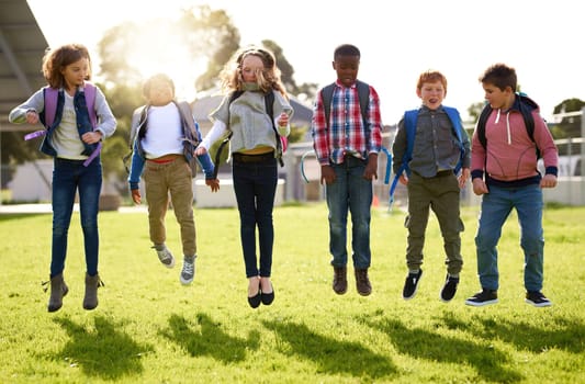 Doing what kids do best, jumping for joy. young kids playing together outdoors