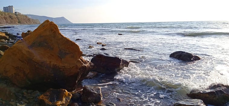 landscape of rocky seashore in clear windy weather