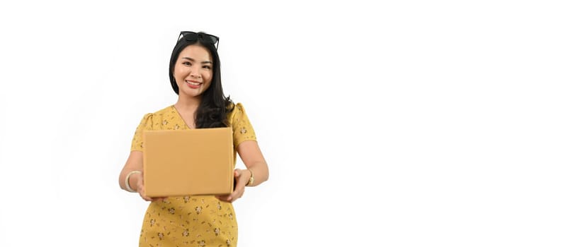 Portrait of smiling woman with parcel cardboard box isolated white background with copy space. Shipping service concept.