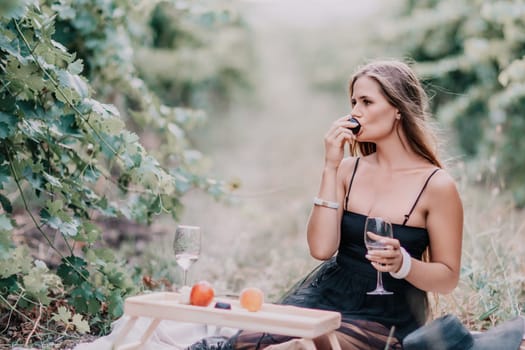 Picnic and wine tasting at sunset in the hills of Italy, Tuscany. Vineyards and open nature in the summer. Romantic dinner, fruit and wine.