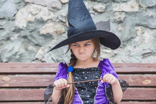 young sorceress is angry and wanting to break the magic wand.