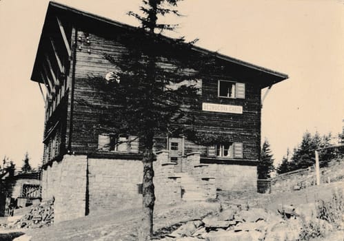 THE CZECHOSLOVAK SOCIALIST REPUBLIC - CIRCA 1960s: Retro photo shows view on mountain cottage. Black and white vintage photography