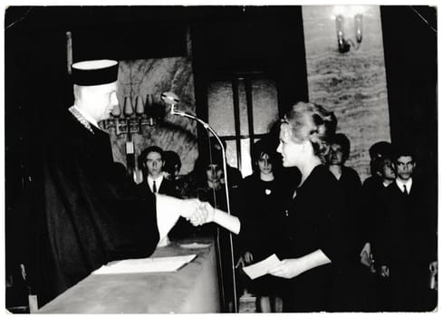 THE CZECHOSLOVAK SOCIALIST REPUBLIC - MARCH 31, 1965: Retro photo shows graduation celebration. Black and white vintage photography