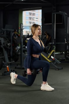 Photo of sporty caucasian woman squatting with small weights