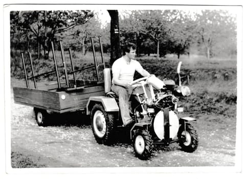 THE CZECHOSLOVAK SOCIALIST REPUBLIC - MAY 17, 1984: Retro photo shows compact tractor. Vintage black and white photography.