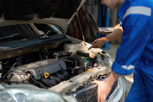 Auto mechanic working in garage. Repair service.