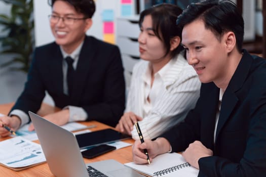 Business team of financial data analysis meeting with business intelligence, report paper and dashboard on laptop for marketing strategy. Business people working together to promote harmony in office.