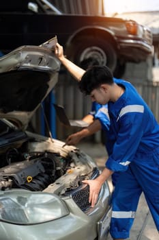 Auto mechanic working in garage. Repair service.