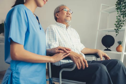 Caring nurse and a contented senior man in a wheel chair at home, nursing house. Medical for elderly patient, home care for pensioners.