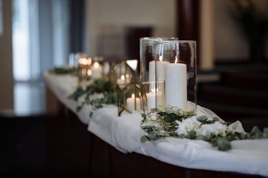 Burning candles oncandlestick against dark background at home. Vintage style. Calm romantic atmosphere. candles in the interior