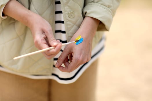 Stop War. Peace in Ukraine. woman drawing picture of flag of ukraine on hand. Antiwar support concept. High quality photo