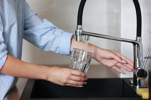 Filling glass of mains water, drinking water close-up. concept of pure drinking water. Water quality check concept. The concept of saving, problems