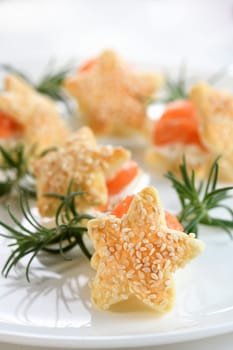 Festive appetizer of puff pastry in the shape of a star, stuffed with salmon and soft cheese. The perfect appetizer for your holiday table.