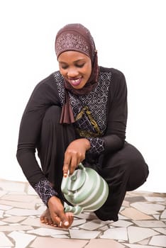 young muslim woman getting ready for prayer.
