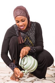 young muslim woman getting ready for prayer.