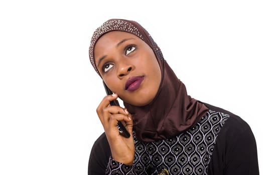young muslim woman sitting interacting with mobile phone.